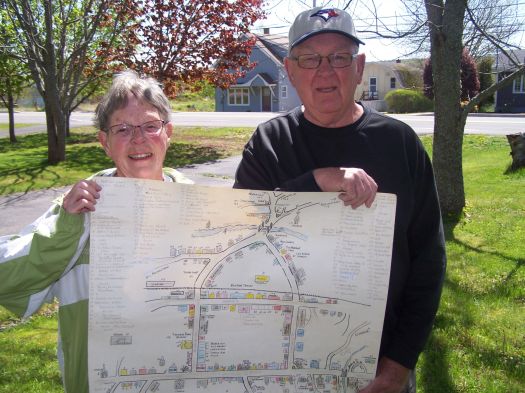 Joan Jefferson and Bob Masters with the map their uncle Bill Chase made of the Kentville retail area as it was circa 1938